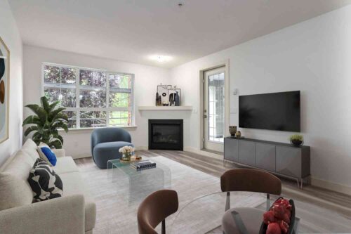 living room with large window and fireplace